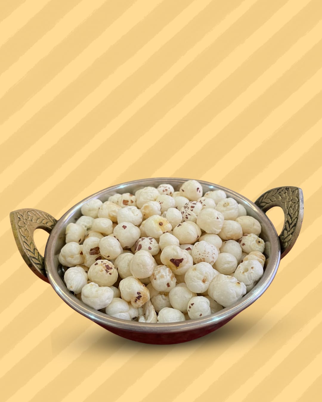 A pan holding 4 Suta Phool Makhana to show the size and texture of the fox nuts for customer reference